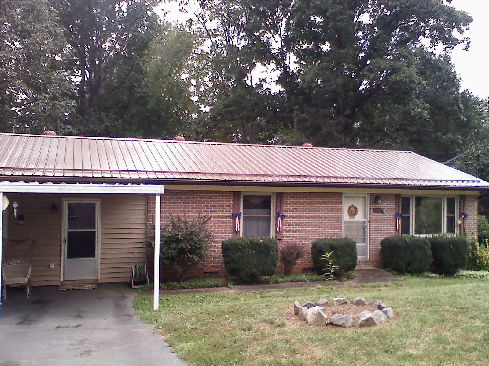 Bronze metal roof and carport on a brick ranch home — Roof Repair work by our crew in Streetsboro